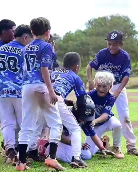 Wolfpack players celebrating together on the field
